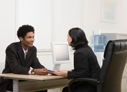 Woman explaining financial brochure to man