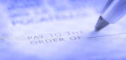 Person writing check with pen and checkbook