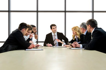 Seven businesspeople having discussion at table