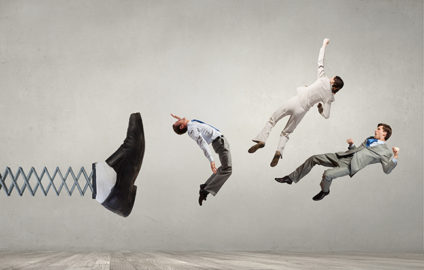 Big businessman foot on spring kicking three businesspeople