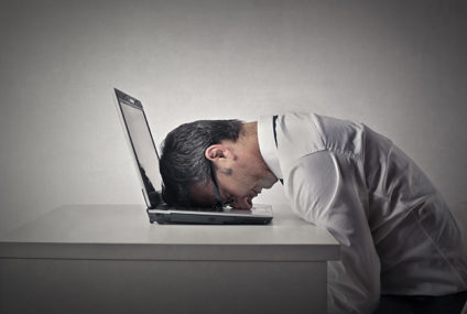 Man with head down on laptop keyboard