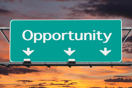 Green "opportunity" highway sign with sunrise background