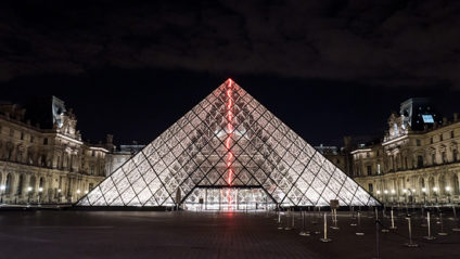 Illuminated glass pyramid at the Louvre, Paris at night