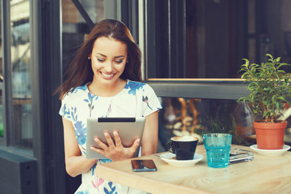 Young woman using a tablet at a cafe