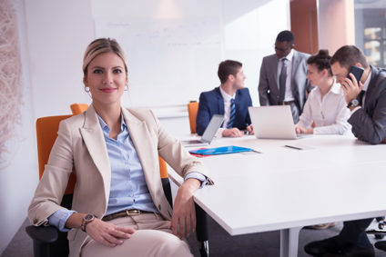 Smiling woman with colleagues in background