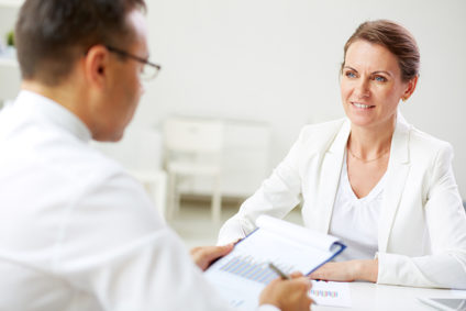 Two people sitting across from each other at a desk