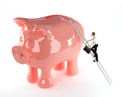 Man with briefcase climbing up ladder to top of giant piggy bank