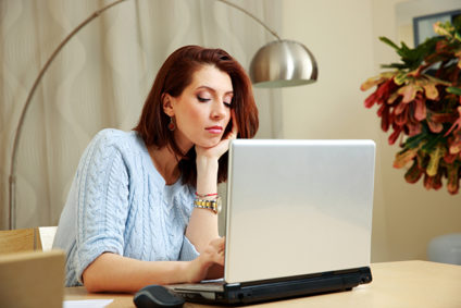 Woman working on laptop at home