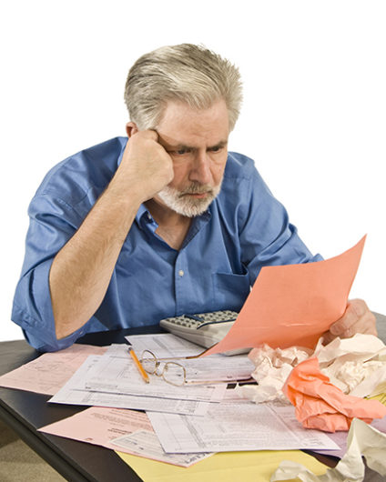 Man staring at pile of paperwork