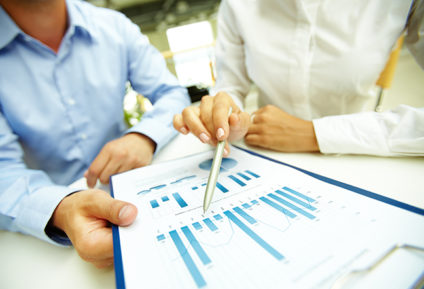 Female hand with pen pointing at document