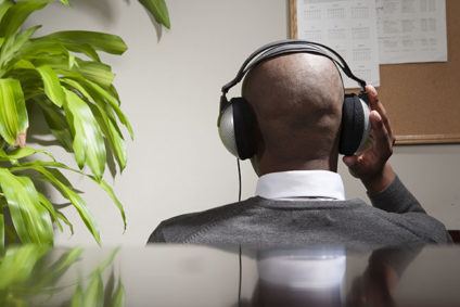 Businessman listening to music in office