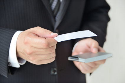 Businessman holding out business card