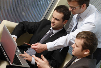 Three young businessmen in office training session