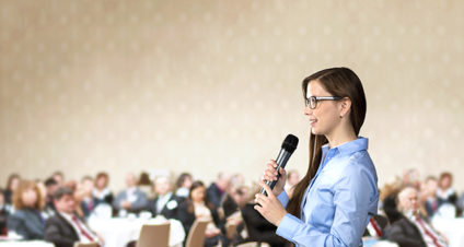 Young woman speaking to crowd