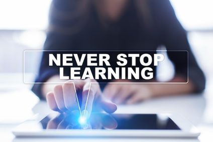 Woman touching tablet and words "Never stop learning"