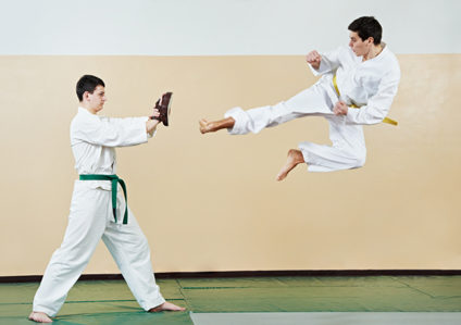 Two men training in tae kwon do at gym