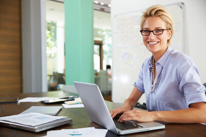 Smiling businesswoman working at desk