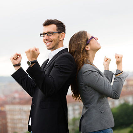 Two partners celebrating business success outside