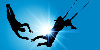 Trapeze artist about to grab partner's hands