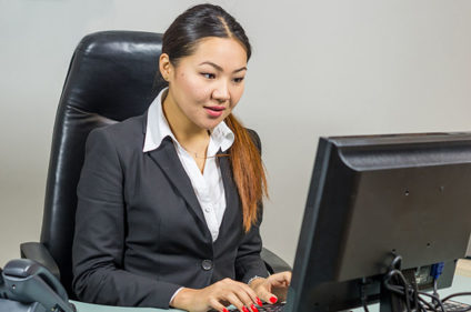 Woman working at desktop computer
