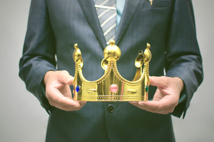 Man in suit holding crown