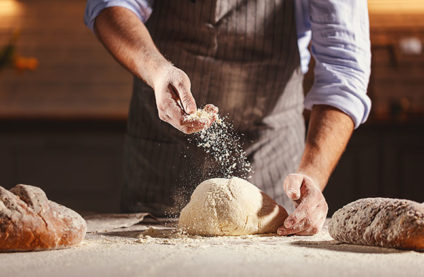 Man preparing bread for baking