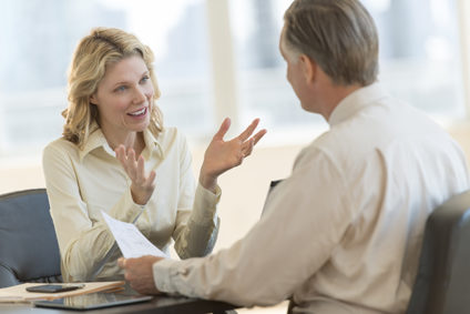 Smiling woman meeting with man in office