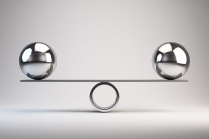 Two metal balls balancing at each end of seesaw