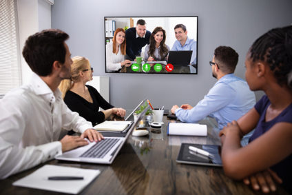 Four people on each side of a videoconference